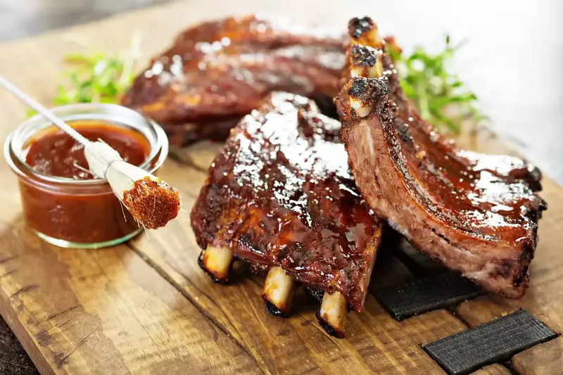 Grilled,And,Smoked,Ribs,With,Barbeque,Sauce,On,A,Carving