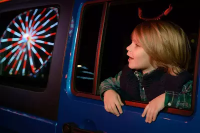 kid looking out the window of a jeep