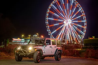 jeep in front of the wheel at the island at night