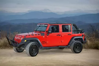 red jeep in front of the mountains