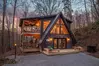 Whispering Waters cabin lit up at dusk